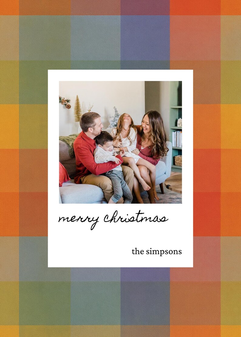 May include: A family portrait inside a white frame with the text "merry christmas" and "the simpsons". The background is a colorful plaid pattern. The family is sitting on a couch and smiling.