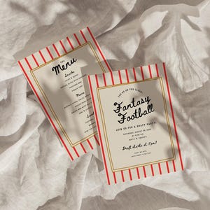 May include: Two cream-colored cards with red and white stripes and gold borders. One card reads "The Menu" with a list of snacks and mains. The other card says "Fantasy Football" and invites guests to a draft party.