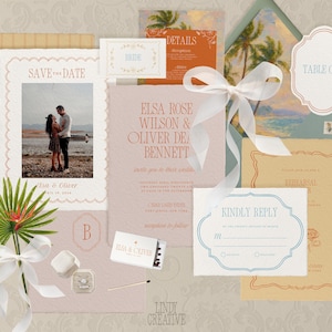 May include: A collection of wedding stationery, including a "Save the Date" card with a photo, invitation, RSVP card, and table card. The color palette includes soft pink, orange, and cream tones, with elegant typography and decorative borders. A white ribbon and palm frond add a touch of natural elegance.