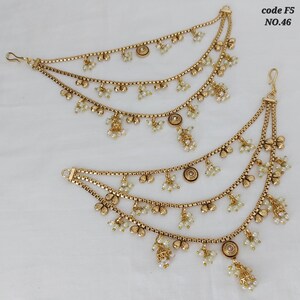 May include: Two gold-toned ear chains with multiple strands. Each chain features small, round, white beads and decorative floral and circular elements. The chains are designed to be worn with earrings, and the image includes the text "code F5 NO.46".
