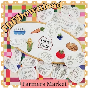 May include: An embroidery hoop containing white fabric with stitched designs of eggs, a carrot, corn, and a tomato, surrounded by various fabric patches featuring black line art of produce, bread, and text including Farm Fresh and eat local.