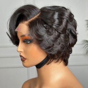 May include: A dark brown, short, wavy wig with a side parting. The wig features a natural-looking hairline and is styled with soft curls. The wig is designed for anyone to wear.