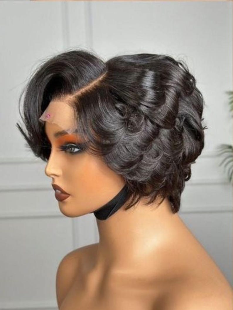 May include: A dark brown, short, wavy wig with a side parting. The wig features a natural-looking hairline and is styled with soft curls. The wig is designed for anyone to wear.