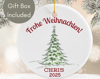 May include: White ceramic Christmas ornament with a hand-drawn green Christmas tree and the words "Frohe Weihnachten!" in red. The ornament also includes the name "CHRIS" and the year "2025".