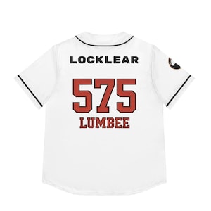 May include: White baseball jersey with black trim, featuring the name "LOCKLEAR" above the number "575" and the word "LUMBEE" in red. A circular emblem is on the right sleeve.