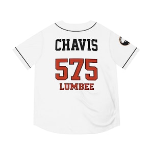 May include: White baseball jersey with black trim and the name "CHAVIS" in black block letters above the number "575" in red with a black outline. The word "LUMBEE" is below the number in red.