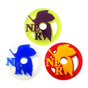 May include: Three colorful, circular emblems with the word "NERV" in a bold font. The emblems are in yellow-green, white, and red, each with a different colored logo. The logos are in purple, blue, and yellow-orange.