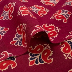 Hand block printed 100% cotton fabric featuring a traditional Indian floral pattern with intricate artisan detailing. Soft, breathable, lightweight fabric sold by the yard, ideal for sewing dresses, blouses, skirts, quilting, patchwork, home décor, cushion covers, curtains, table linens, tote bags, and a variety of DIY craft projects. Perfect for fashion designers, crafters, and handmade creations.