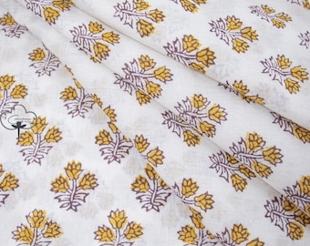 May include: White cotton fabric with a repeating pattern of mustard yellow and brown floral sprigs.