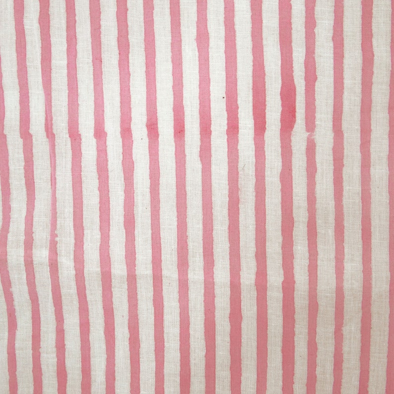May include: Pink and white striped fabric with a subtle linen texture.