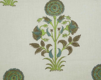 May include: A white fabric with a repeating pattern of green and brown floral designs. The flowers are stylized and have a blue center.