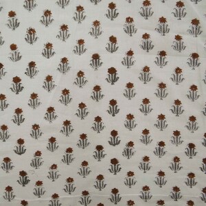 Grey White floral hand block print cotton fabric featuring traditional Indian artisan craftsmanship on soft lightweight cotton. This handmade Jaipur block printed fabric is shown in a swirl drape to highlight its smooth texture, natural flow, and elegant floral motif. Perfect for dressmaking, quilting, sewing, kurtas, summer dresses, blouses, home décor, DIY crafts, and fabric by the yard projects. 
 
block print fabric, fabric by the yards, cotton fabric, hand dyed fabric, Indian cotton fabric