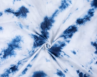 May include: White fabric with a blue tie-dye pattern. The fabric is folded in the center, creating a swirl effect.