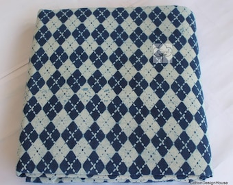 May include: Blue and white cotton fabric with a diamond pattern. The fabric is folded in half and has a subtle distressed look.