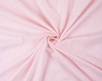May include: A close-up of a soft, pale pink fabric with a smooth texture. The fabric is folded and draped, creating a gentle, flowing effect.