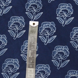 Hand block printed 100% cotton fabric featuring a traditional Indian floral pattern with intricate artisan detailing. Soft, breathable, lightweight fabric sold by the yard, ideal for sewing dresses, blouses, skirts, quilting, patchwork, home décor, cushion covers, curtains, table linens, tote bags, and a variety of DIY craft projects. Perfect for fashion designers, crafters, and handmade creations.