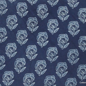 Hand block printed 100% cotton fabric featuring a traditional Indian floral pattern with intricate artisan detailing. Soft, breathable, lightweight fabric sold by the yard, ideal for sewing dresses, blouses, skirts, quilting, patchwork, home décor, cushion covers, curtains, table linens, tote bags, and a variety of DIY craft projects. Perfect for fashion designers, crafters, and handmade creations.