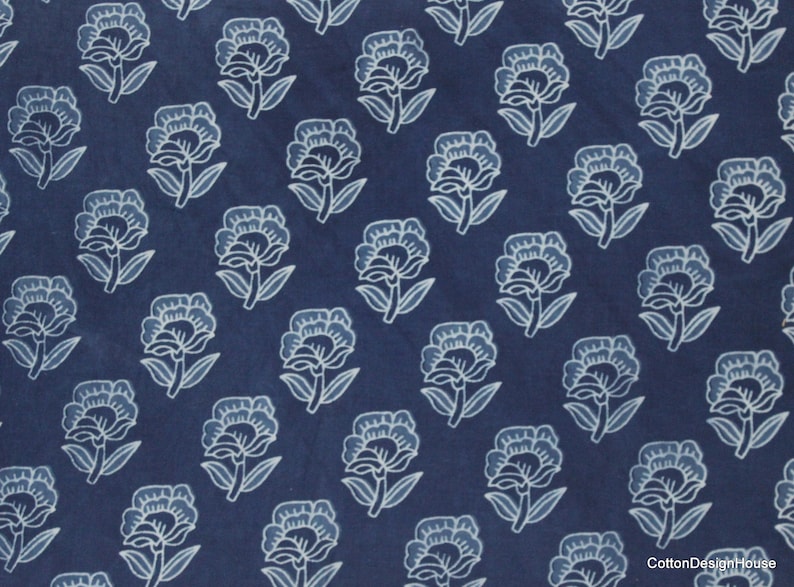 Hand block printed 100% cotton fabric featuring a traditional Indian floral pattern with intricate artisan detailing. Soft, breathable, lightweight fabric sold by the yard, ideal for sewing dresses, blouses, skirts, quilting, patchwork, home décor, cushion covers, curtains, table linens, tote bags, and a variety of DIY craft projects. Perfect for fashion designers, crafters, and handmade creations.
