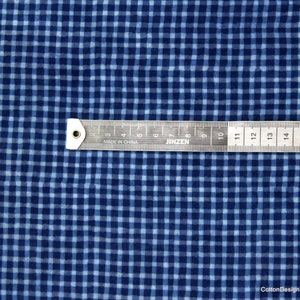 May include: Blue and white gingham fabric with a ruler measuring 16 inches. The fabric has a subtle texture and a slightly faded look.