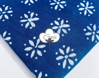 May include: Blue cotton fabric with a white floral pattern. The fabric is folded in the corner and has a white cotton logo with the text "cotton design house" in the center.
