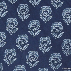Hand block printed 100% cotton fabric featuring a traditional Indian floral pattern with intricate artisan detailing. Soft, breathable, lightweight fabric sold by the yard, ideal for sewing dresses, blouses, skirts, quilting, patchwork, home décor, cushion covers, curtains, table linens, tote bags, and a variety of DIY craft projects. Perfect for fashion designers, crafters, and handmade creations.