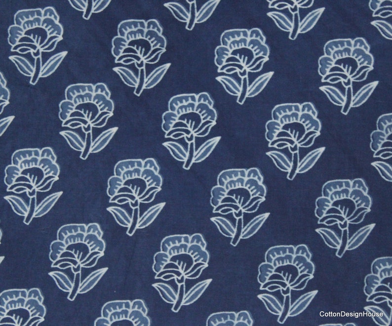 Hand block printed 100% cotton fabric featuring a traditional Indian floral pattern with intricate artisan detailing. Soft, breathable, lightweight fabric sold by the yard, ideal for sewing dresses, blouses, skirts, quilting, patchwork, home décor, cushion covers, curtains, table linens, tote bags, and a variety of DIY craft projects. Perfect for fashion designers, crafters, and handmade creations.