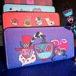 May include: A stack of zip-around wallets in various colors, featuring cartoon character designs. The wallets are red, purple, blue, and maroon. The purple wallet has a gradient design and features three characters. The red wallet has four cartoon character designs.