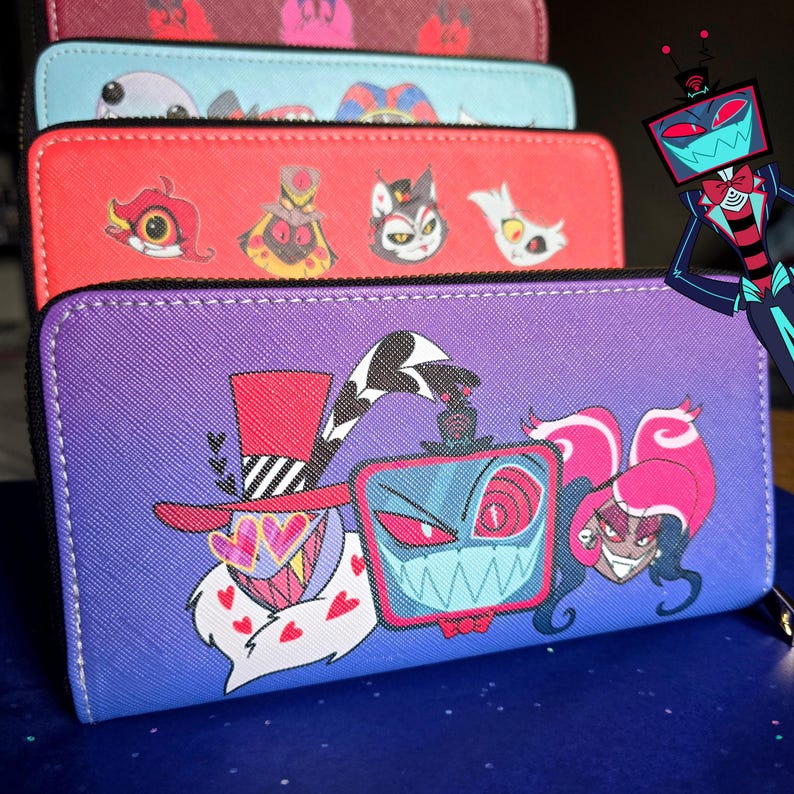 May include: A stack of zip-around wallets in various colors, featuring cartoon character designs. The wallets are red, purple, blue, and maroon. The purple wallet has a gradient design and features three characters. The red wallet has four cartoon character designs.