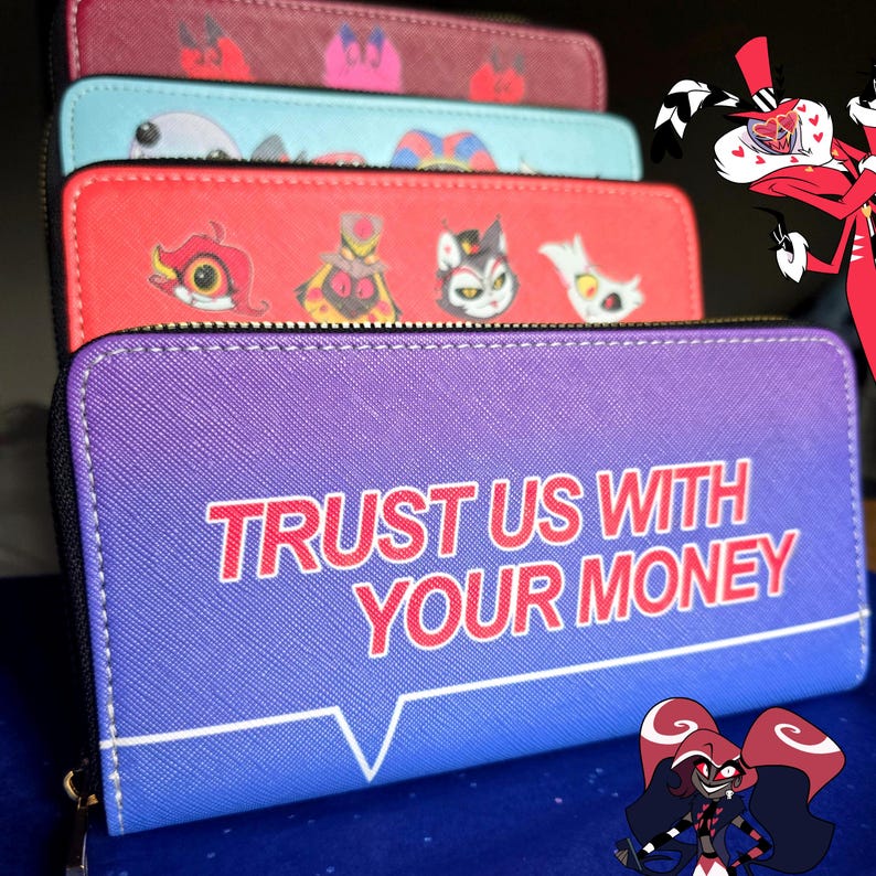 May include: A stack of zippered wallets in various colors, including purple, red, and teal. The purple wallet features the text "TRUST US WITH YOUR MONEY." Other wallets display cartoon character designs. The wallets are likely made of faux leather.