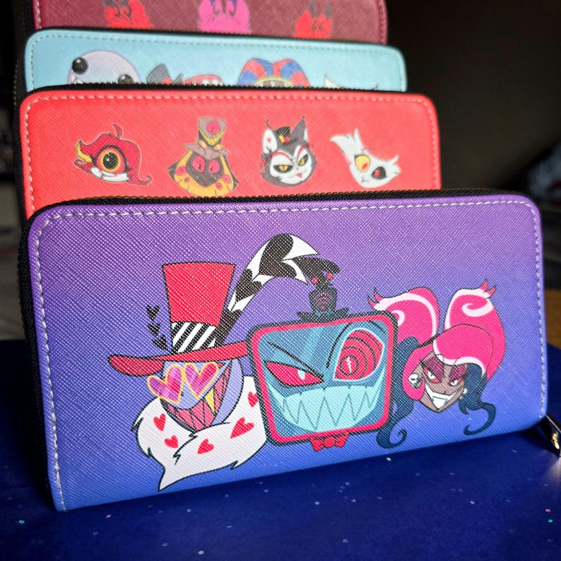 May include: A stack of zippered wallets in various colors, each featuring cartoon character designs. The wallets are purple, red, blue, and maroon. The purple wallet has a gradient background and a cartoon character design.