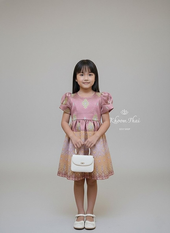 lao silk dress "This dress is made of red Lao silk with golden stripes and symbolizes patience. It was inspired by the craftsmanship and wisdom of her country's people that has been passed down from generation to