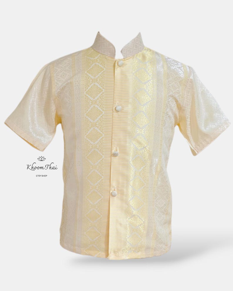 May include: A cream-coloured short-sleeved shirt with a mandarin collar and a button-up front. The shirt has a geometric pattern in a lighter shade of cream.