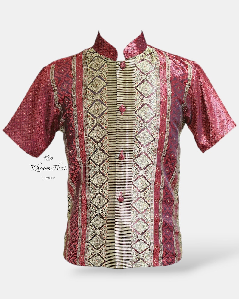 May include: A red and gold short-sleeved shirt with a mandarin collar and a button-up front. The shirt features a traditional Thai pattern.