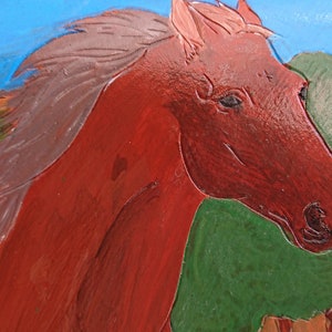 May include: A close-up of a painted horse head in shades of red and brown. The horse's mane is a lighter shade of brown. The background features green and blue colors, suggesting a landscape.