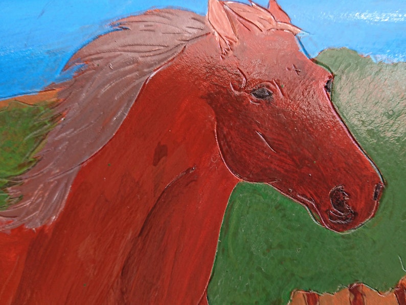 May include: A close-up of a painted horse head in shades of red and brown. The horse's mane is a lighter shade of brown. The background features green and blue colors, suggesting a landscape.
