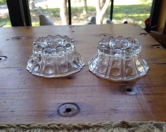 A pair of clear pressed glass bubble candle holders