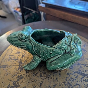 May include: A rustic wooden sign with the text "Welcome to our home" in white lettering. The sign features a distressed finish and a simple, inviting design, perfect for front door decor.