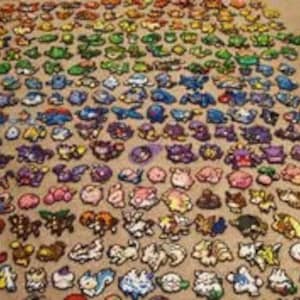 May include: A rainbow-colored collection of over 150 pixel art Pokemon characters created with colorful beads. Each character is individually crafted and displayed in rows, creating a vibrant and eye-catching display.