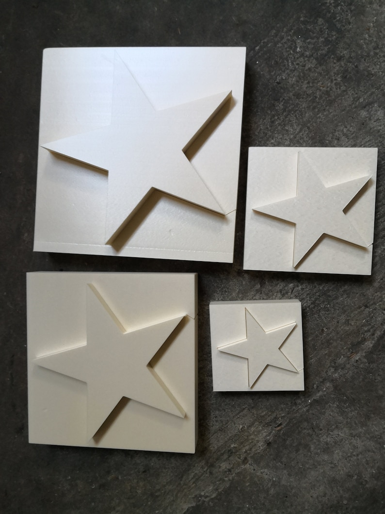 May include: Four white foam star shapes of varying sizes. The stars are cut out of the foam and are ready to be used for crafts or decorations.