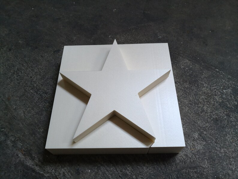 May include: A white foam star shape, cut out from a larger square piece of foam.