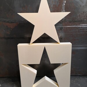 May include: Two white foam stars, one large and one small. The large star is on top of the small star, which is cut out of a square piece of foam.