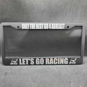 May include: Black metal license plate frame with the text "ONLY THE BEST GO 4 ABREAST" and "LET'S GO RACING" with a small image of a race car on each side.