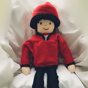 Hand made male Rag Doll dressed to ice skate with trousers, fleece, vest with skating quip,, hat & skates.