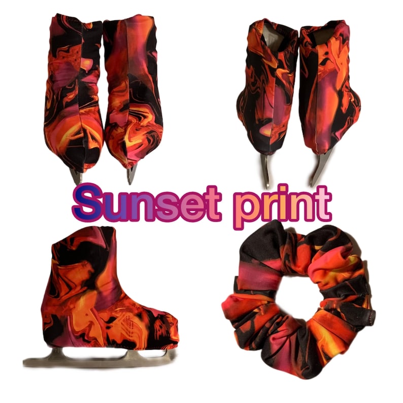 May include: A set of ice skate covers with a sunset print. The covers are black with orange, pink, and yellow swirls. The set includes two covers for the skates and a hair scrunchie with the same print.