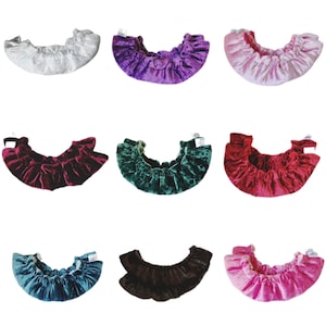 Puede incluir: Nueve coleteros de terciopelo en varios colores, incluyendo plateado, morado, rosa, burdeos, verde esmeralda, rojo, turquesa, marrón y rosa intenso. Cada coletero está recogido con una banda elástica.