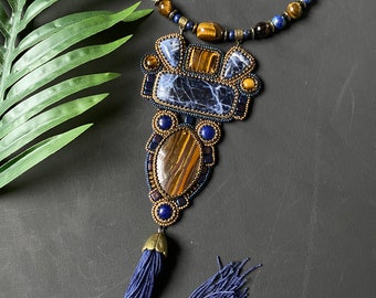 Bead embroidery necklace with stones. Necklace embroidered with beads with tiger's eye and sodalite stones, sautoir with pendant and tassel