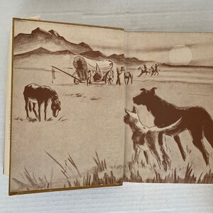 May include: A vintage illustration depicting a covered wagon travelling across a prairie, with a lone donkey in the foreground. The wagon is drawn by oxen and has a canvas top. The illustration is in shades of brown and white.