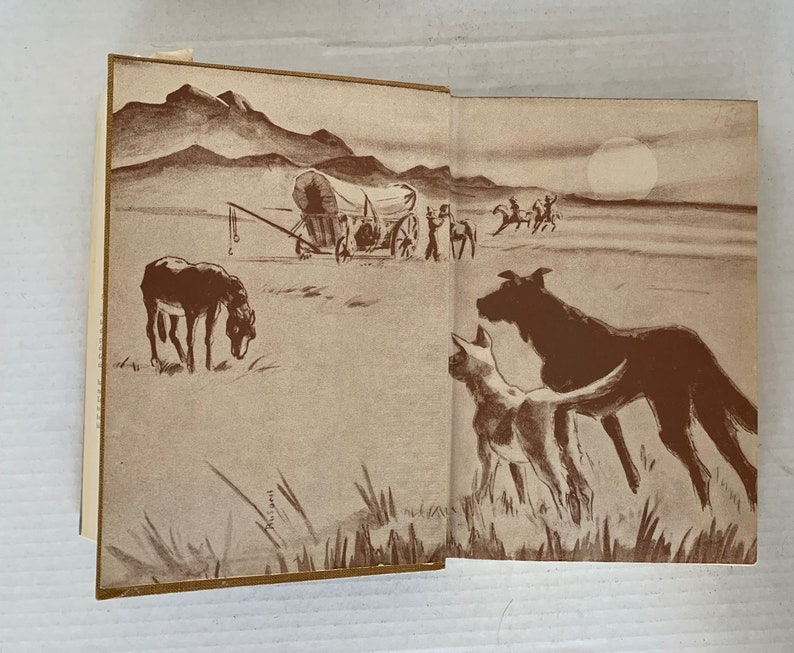 May include: A vintage illustration depicting a covered wagon travelling across a prairie, with a lone donkey in the foreground. The wagon is drawn by oxen and has a canvas top. The illustration is in shades of brown and white.