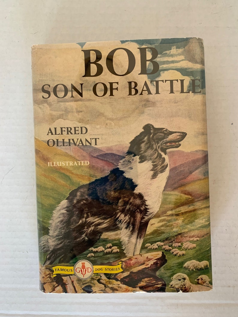 May include: A vintage book cover featuring a black and white dog standing in a field with sheep. The title of the book is "Bob Son of Battle" by Alfred Ollivant. The book is illustrated and part of a series called "Famous Dog Stories".