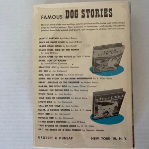 May include: A book cover with a blue background and the title "Famous Dog Stories". The cover features illustrations of dogs from various breeds, including a wolf, a terrier, and a hound. The book is published by Grosset & Dunlap.